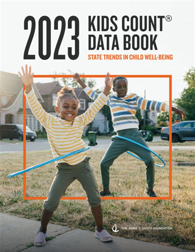 2023 National KIDS COUNT Data Book cover. Image of two children playing hula hoop outdoors