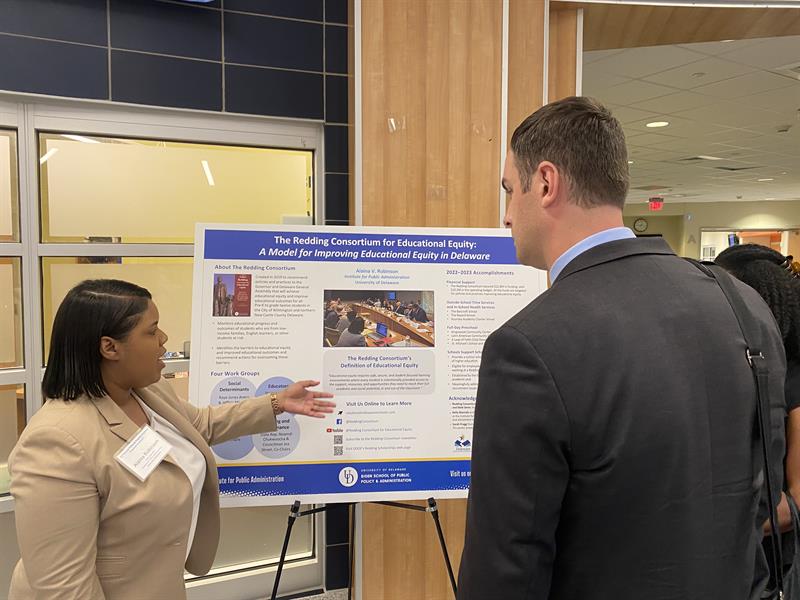 Image of Alaina Robinson presenting a poster presentation at the 21st Annual Policy and Practice Institute: Delaware's Conference on Public Education