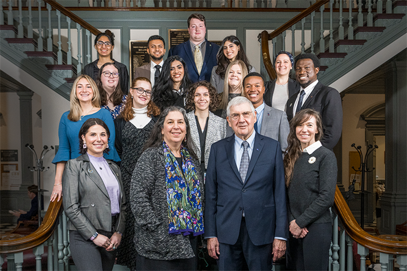 Image of our 14 Legislative Fellows (2023) posing with (from left to right) Dean Amy Schwartz, Dr. Jerome Lewis, and Lisa Moreland Allred