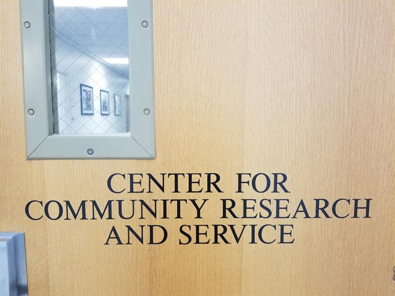 Door with sign that reads Center for Community Research and Service