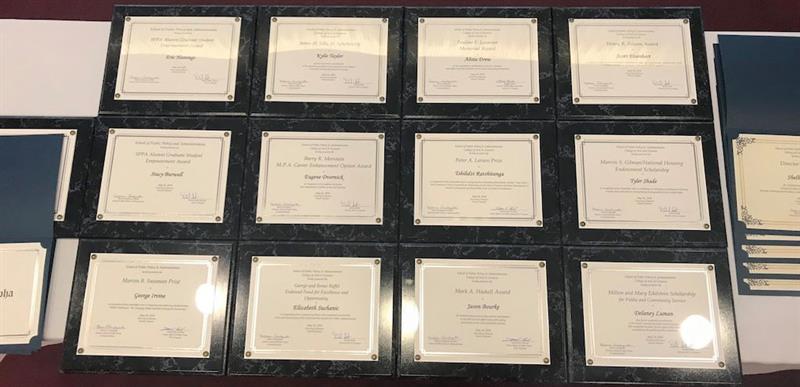 plaques laid out on a table for Honors Day