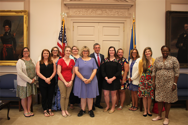Eleven participants of the 2018 Democracy Project Summer Institute for Teachers meet with Delaware Governor John Carney in his office.