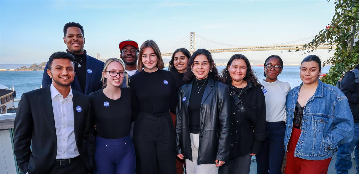 A group of interns stand in front of the San Franscisco Bay Bridge.
