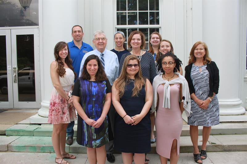 School director, IPA director, and staff coordinators stand with the 2019 Local Government Management Fellows. 
