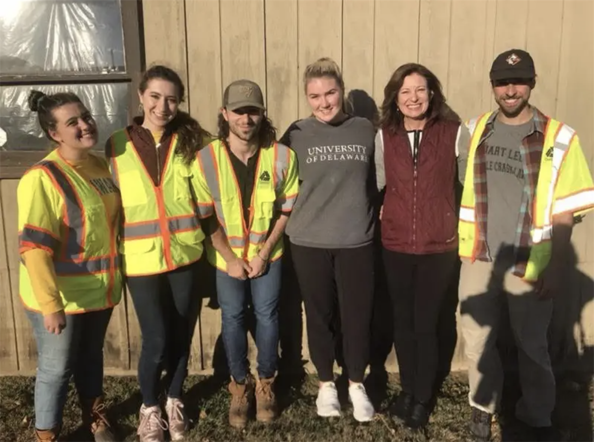 Six people in reflective vests pose for a picture.