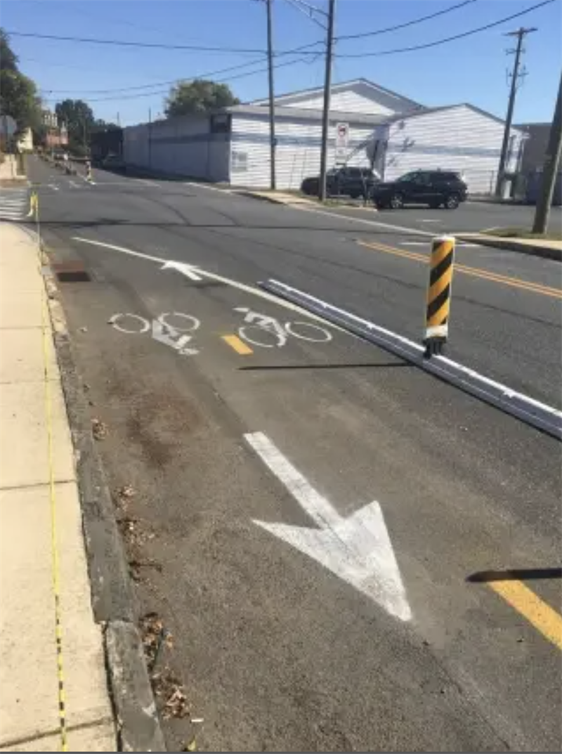 A bike lane with an arrow on a road.