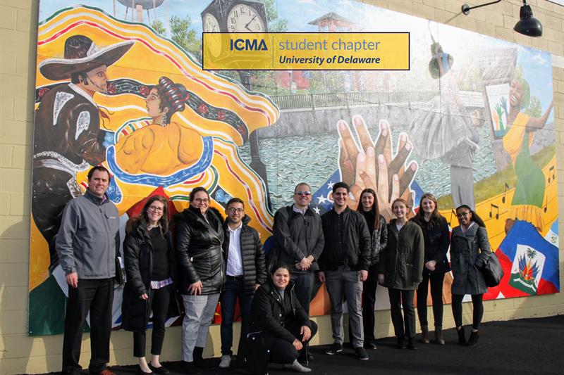 ICMA Student Chapter members stand in front of a mural in Milford, Delaware.