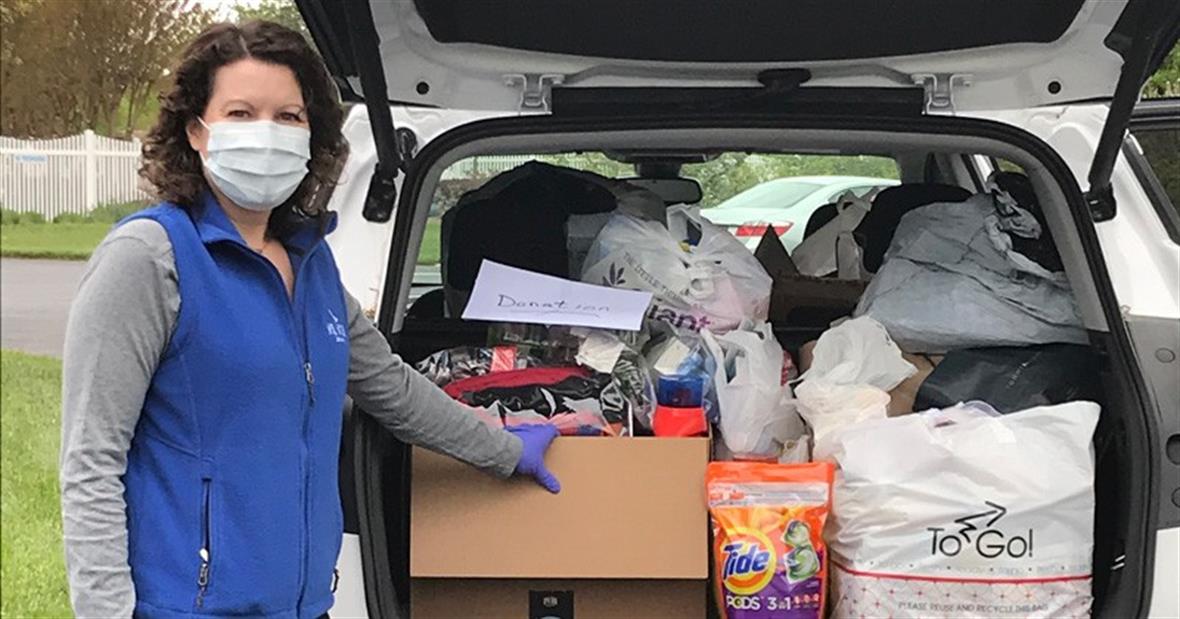 Danielle Swallow stands next to an SUV full of donations.
