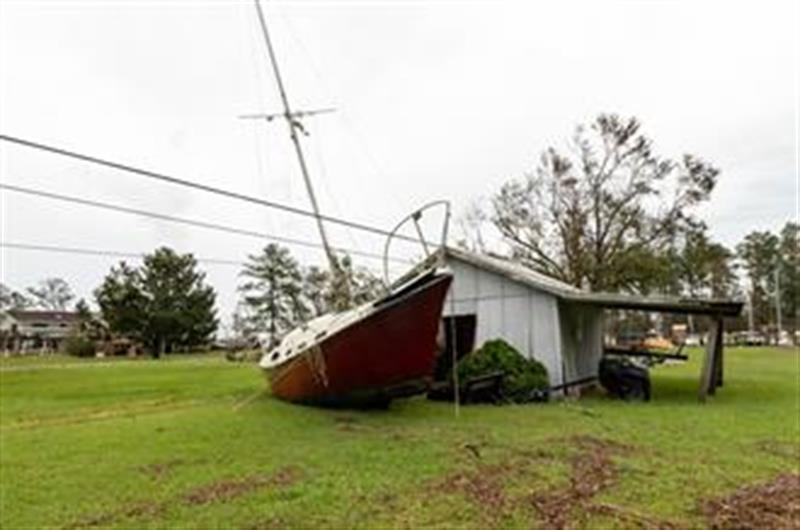 The storm surge from Hurricane Florence made this boat and this home neighbors in North Carolina.