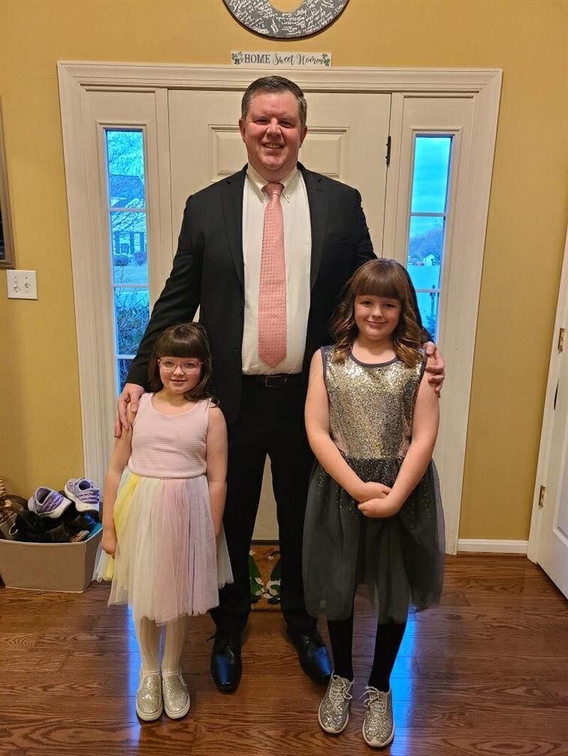 Image of Sean T. O'Neill pictured with his daughters for a daddy-daughter dance event