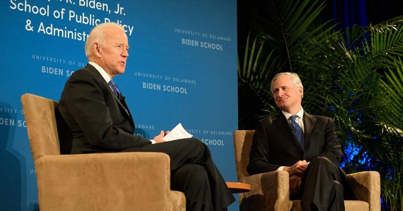 Joe Biden and Jon Meacham having a conversation on a stage.