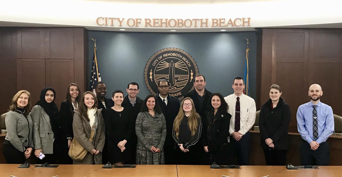 Students pose in front of the City of Rehoboth Beach seal.