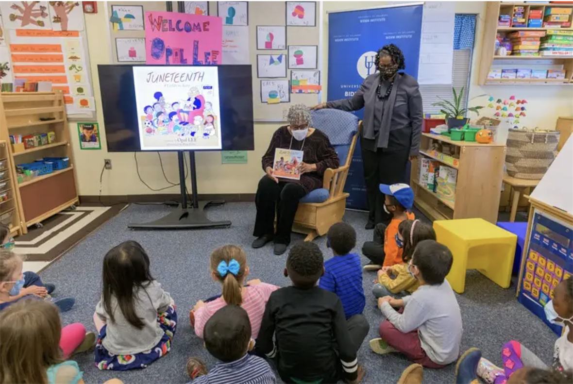 Opal Lee reading to young children.