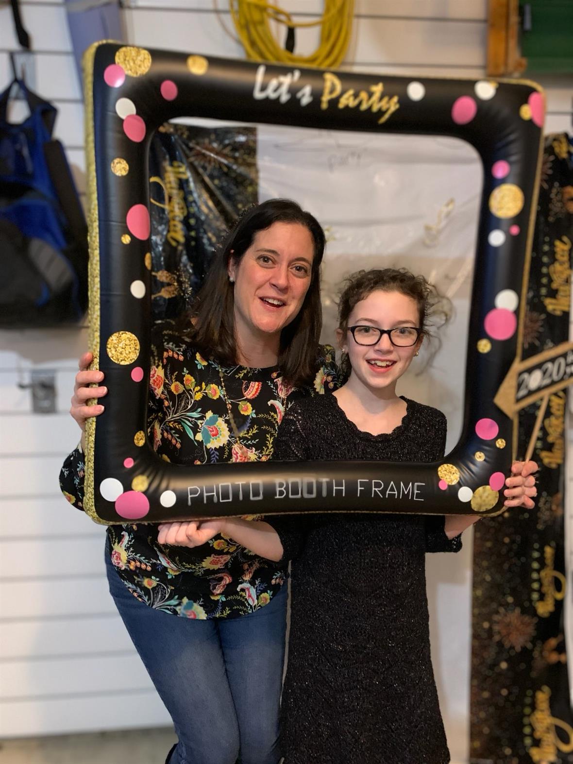 Kelly and Izzy Sherretz pose for a photo with an inflatable photo frame.